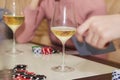 Players of poker game with chips and cards close up. Glasses of champagne. Gambling concept. Candid moment. Selective Royalty Free Stock Photo
