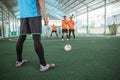 Players preparing to kick the ball blocked by a posse