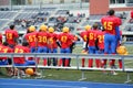 Players on sidelines at high school football game