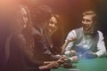 Players sitting at the playing table in the casino Royalty Free Stock Photo
