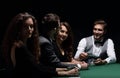 Players sitting at the playing table in the casino Royalty Free Stock Photo