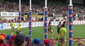 Players and umpire looking the footy crossing the goal posts line in the air at Ikon Park Stadium