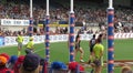 Players and umpire looking the footy crossing the goal posts line in the air at Ikon Park Stadium Royalty Free Stock Photo