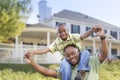 Playful African American Father and Son In Front of Home