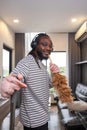 Playful African man in casual clothes Clean the dust or dirtiness of the room happily and have fun cleaning.