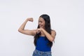 A playful asian woman shows off her biceps. Lighthearted scene isolated on a white background