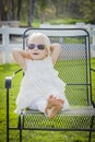 Playful Baby Girl Wearing Sunglasses Outside at Park