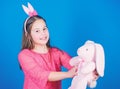 Playful beauty. Little girl with hare toy. Egg hunt. Family holiday. Happy easter. Spring party. Child in rabbit bunny Royalty Free Stock Photo