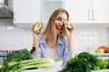 Playful Blonde Posing With Halves of Avocado