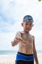 Playful boy and Hermit crab on the beach. Royalty Free Stock Photo