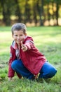 Playful boy shooting with finger at camera Royalty Free Stock Photo