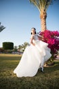 Playful bride. Bride luxury white wedding dress sunny day tropic nature background. Tropic wedding. Woman pretty wear