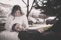 Playful Bride and Groom Sitting on a Bench Royalty Free Stock Photo