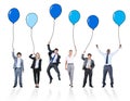 Playful Business People Holding Multicolored Balloons Royalty Free Stock Photo