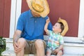 Playful Caucasian Father and Mixed Race Chinese Son Wearing Cowboy Hats