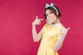 Playful charming young woman pointing on bubble gum balloon Royalty Free Stock Photo