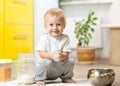 Playful child boy with face in flour surrounded Royalty Free Stock Photo