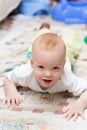 Playful child crawling on the carpet Royalty Free Stock Photo