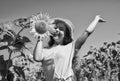 Playful child girl harvesting beautiful sunflowers at farm, happy childhood Royalty Free Stock Photo