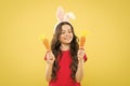 Playful child yellow background. Holy Week activities. Healthy food. Child bunny ears. Diet for health. Benefit of