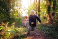 Playful children catch up with each other in park. Children play catch up game. little boy and girl are running in forest Royalty Free Stock Photo