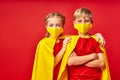 Playful children in heroes cloaks and medical masks posing Royalty Free Stock Photo