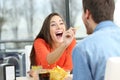 Playful couple eating chip potatoes