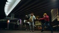 Playful couple having fun on street. Pair playing funny fight under bridge. Royalty Free Stock Photo