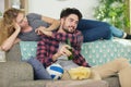 playful couple in love sitting on couch Royalty Free Stock Photo