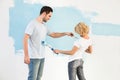 Playful couple painting each other in new house Royalty Free Stock Photo