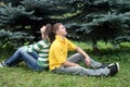 Playful couple sitting in park Royalty Free Stock Photo