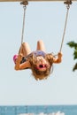 Playful crazy girl on swing.