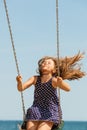 Playful crazy girl on swing.