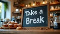Playful cursive Take a Break on caf chalkboard pastries coffee on counter Royalty Free Stock Photo