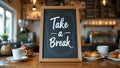 Playful cursive Take a Break on caf chalkboard pastries coffee on counter Royalty Free Stock Photo