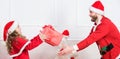 Playful daughter and dad celebrate christmas. Winter activity and fun. Child pretend to fight for christmas gifts