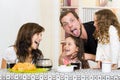 Playful family with two girls eating breakfast Royalty Free Stock Photo