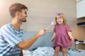 Father casting spell on daughter with magic wand Royalty Free Stock Photo