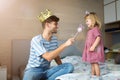 Father casting spell on daughter with magic wand Royalty Free Stock Photo