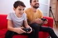 Playful father and son playing video game Royalty Free Stock Photo