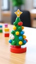 Playful Festivity: Christmas Tree Made of Multicolored Plastic Toys on a Wooden Table