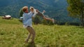 Happy father circling daughter sunny day on green grass mountain meadow. Royalty Free Stock Photo