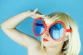 Playful girl with funny glasses, Happy naughty blonde hair woman. Royalty Free Stock Photo