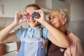 Playful girl and her grandmother having fun with cookie-cutters Royalty Free Stock Photo