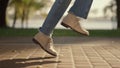 Playful girl legs walking sunny slabbed road park leaving shadow behind closeup. Royalty Free Stock Photo