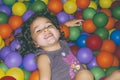 Playful girl lying in ball pit Royalty Free Stock Photo