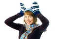 Playful girl wearing mittens, warm hat and scarf