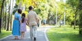 Playful Grandfather and Grandma spending time with his granddaughter in park on sunny day happily. concept grandparent Royalty Free Stock Photo