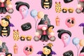 Playful halloween pink gnome with balloons and halloween ornaments illustration isolated on pink background