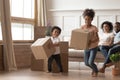 Playful small kids playing carrying boxes on moving day Royalty Free Stock Photo